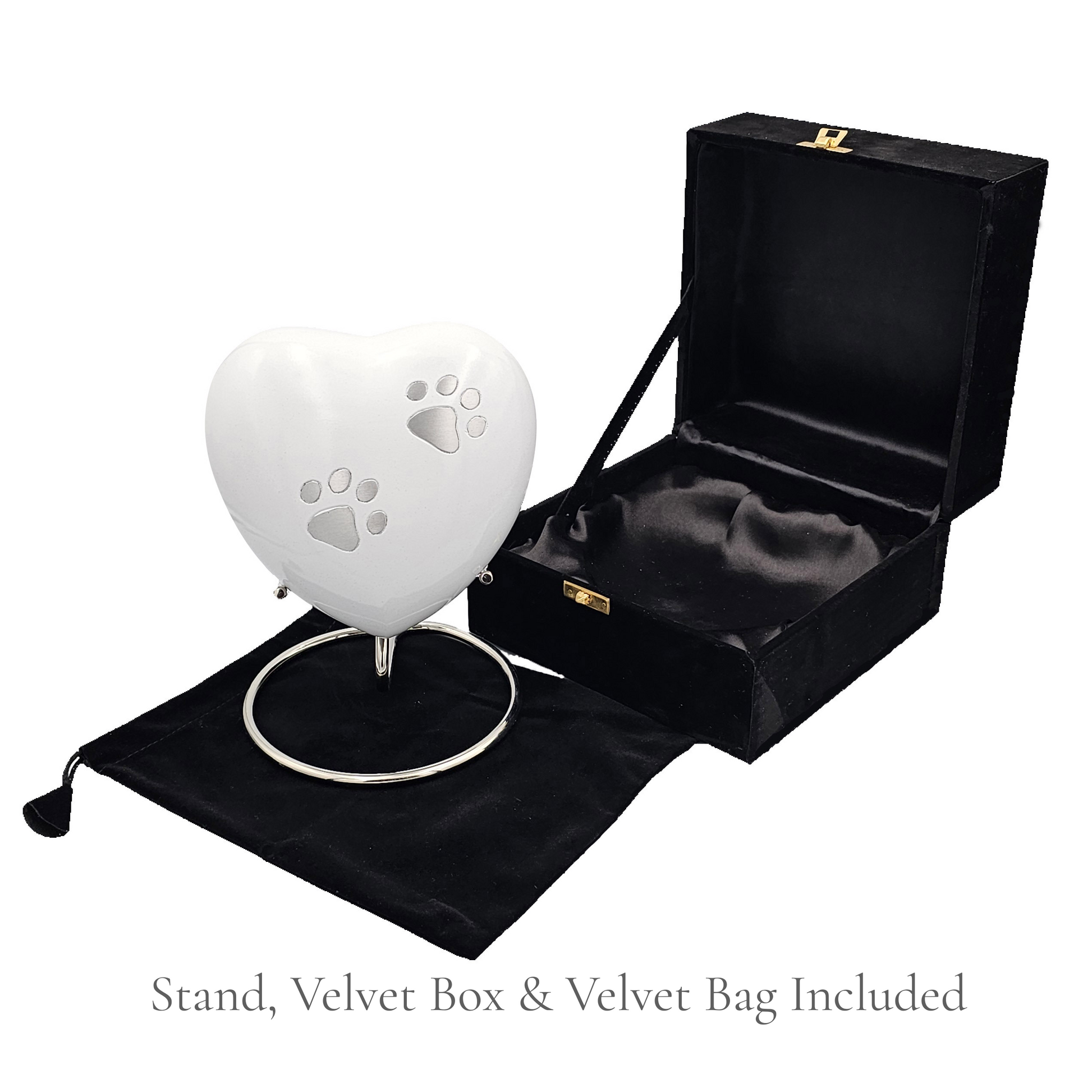 White heart-shaped product with paw prints on a stand, inside an open black velvet box with a black velvet bag.