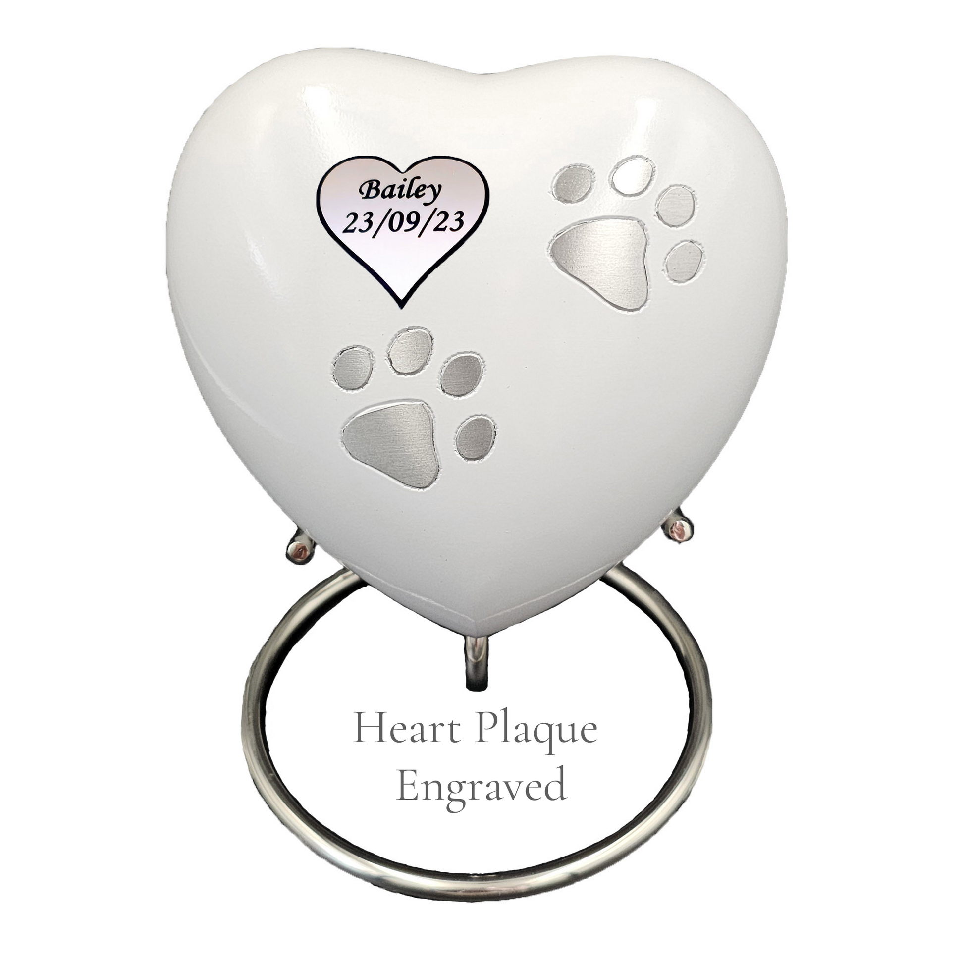 Heart-shaped pet memorial with engraved text on heart plaque on a white heart urn