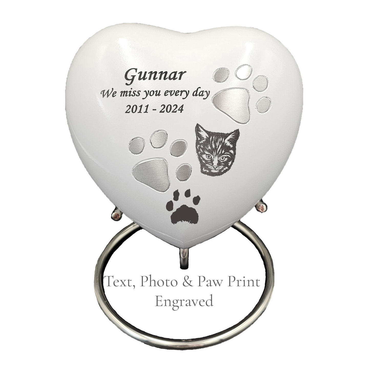 Heart-shaped pet memorial with engraved text and paw prints on a white  heart urn 