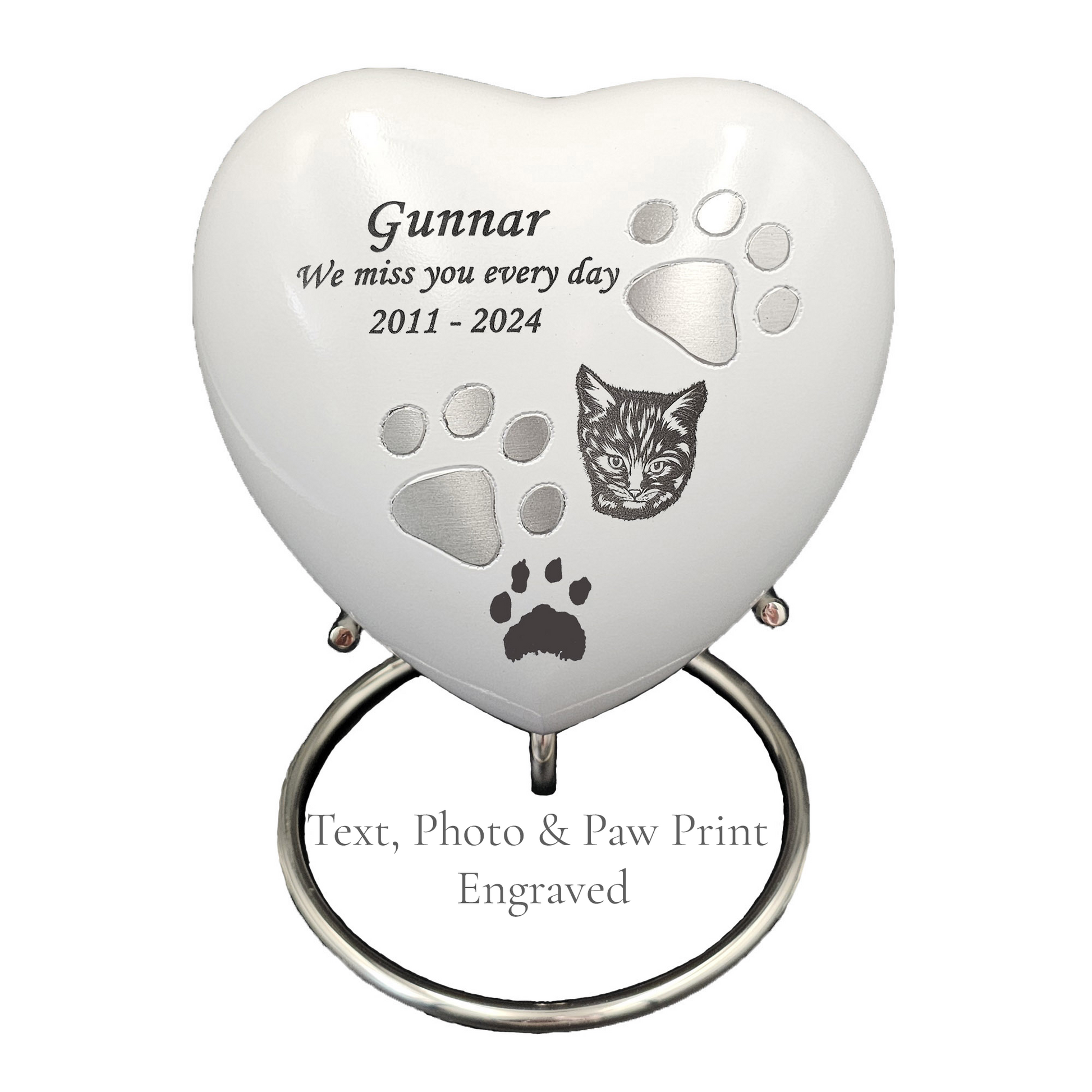 Heart-shaped pet memorial with engraved text and paw prints on a white  heart urn 
