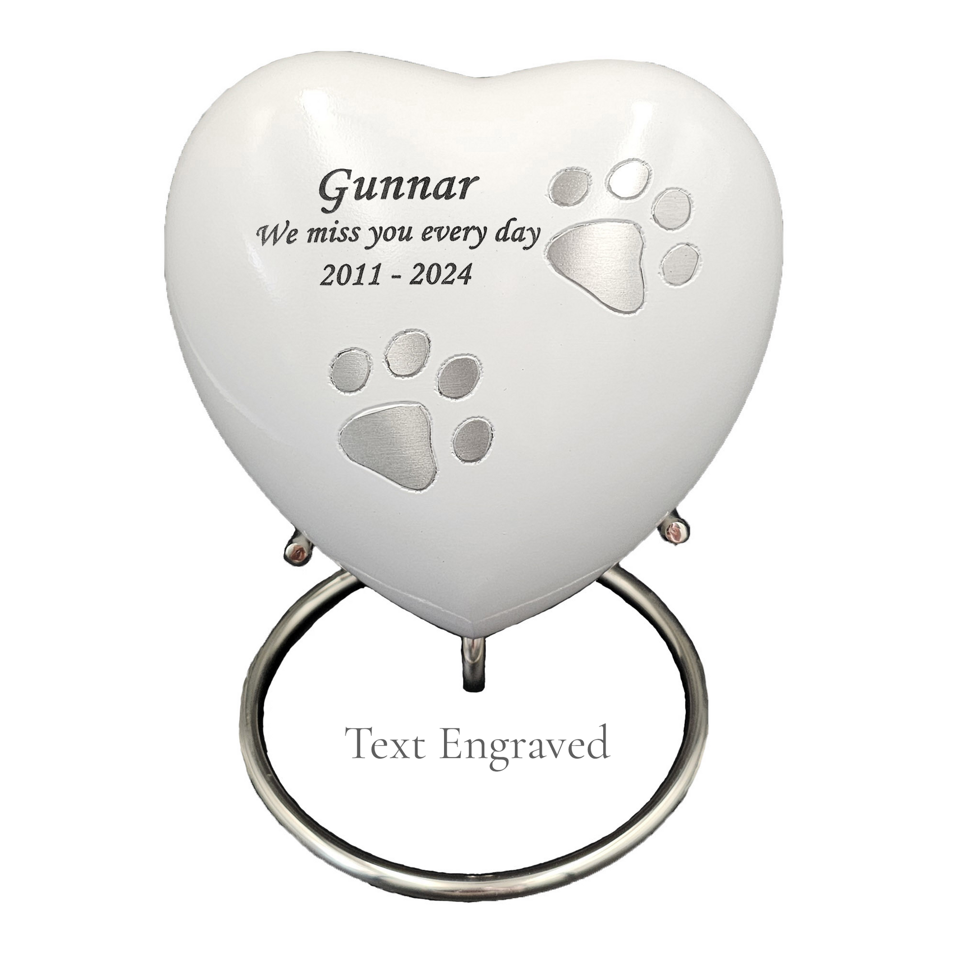 Heart-shaped pet memorial with engraved text on a white heart urn